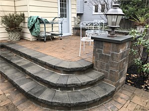 curved raised patio porch back steps light post pier tan gray brick tumbled port washington gray grey